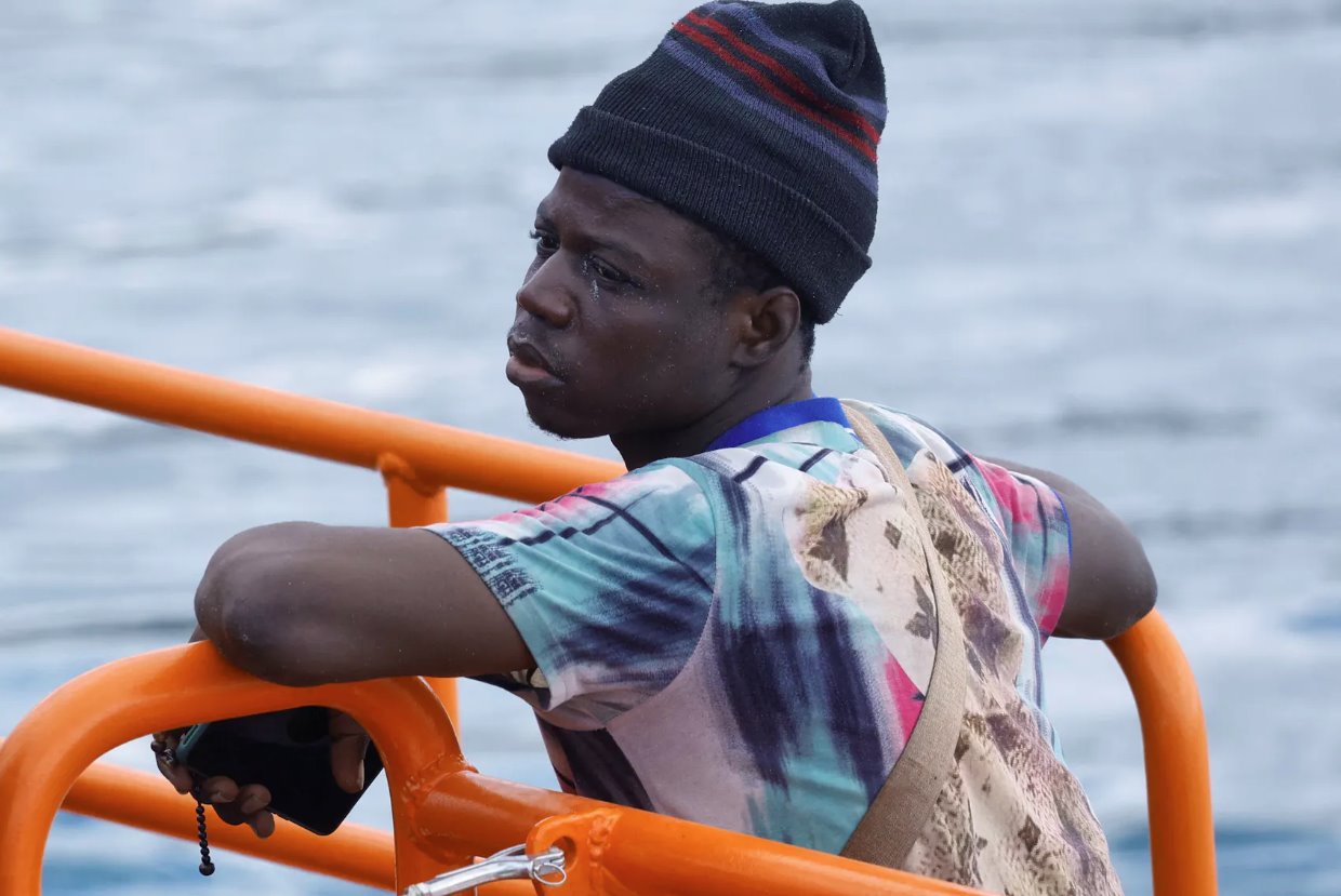 2024年3月28日,在西班牙大加那利島的阿爾吉內(nèi)金港,一名移民正在等待從西班牙海岸警衛(wèi)隊(duì)的船只上下來(lái)。